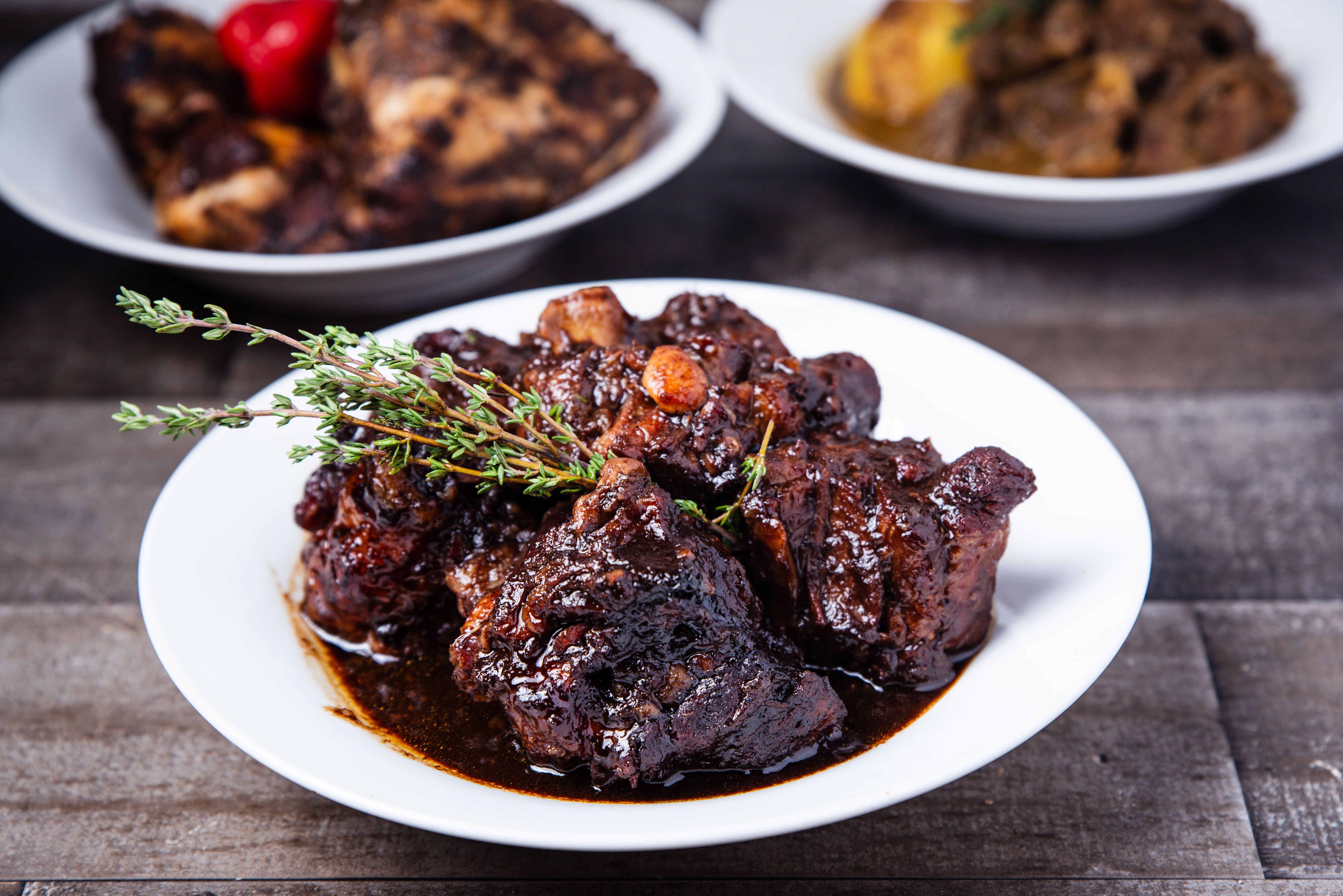 Slow-cooked Jamaican oxtail stew with butter beans in a rich dark gravy